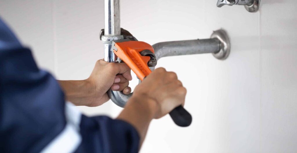 plumber at work in a bathroom, plumbing repair service, assemble and install concept.