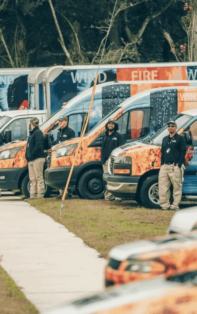 dreyer's team standing outside of service trucks